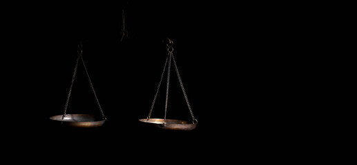 Scales of justice on black background. Copy space.