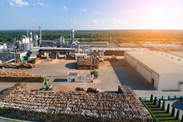 Aerial view of wood processing factory with stacks of lumber at plant manufacturing yard