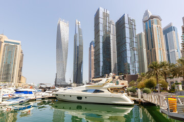 Dubai Marina and Harbour skyline architecture wealth luxury travel in United Arab Emirates with boats yacht