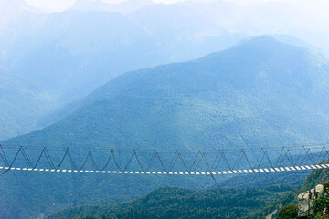 Hanging rope bridge for extreme walking in the mountains 