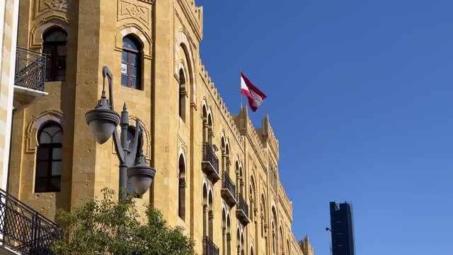 Lebanese flag waving on top of a building in downtown Beirut - Lebanon
