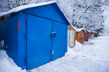 Bright blue barn covered with snow