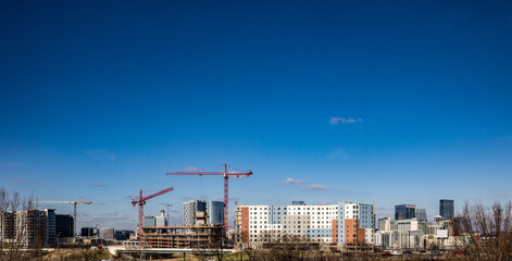 Fototapeta premium Landscape panorama of cranes and other construction equipment building new properties in downtown Nashville, Tennessee 