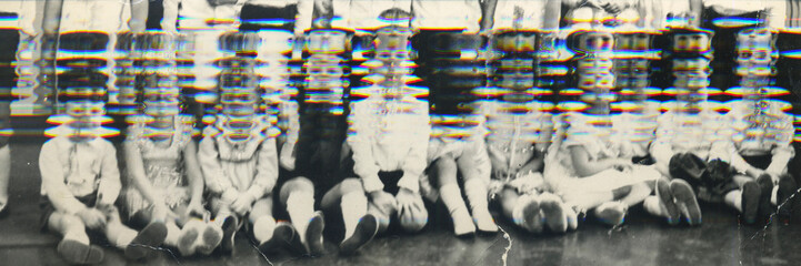 Vintage glitch photo of group of schoolmates kids in their classroom. Retro photo shows small...