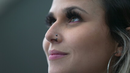 Young woman closing eyes in meditation, person opening eye to sky smiling