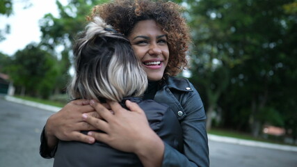 Two female friends relationship, authentic real life diverse friendship together laughing and smiling