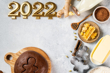 Christmas Baking background. Ingredients for cooking christmas baking on light background. Top view with copy space. Gingerbread cookies. Baking Ginger cookies. Raw dought for cookies. Number 2022