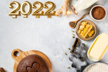 Christmas Baking background. Ingredients for cooking christmas baking on light background. Top view with copy space. Gingerbread cookies. Baking Ginger cookies. Raw dought for cookies. Number 2022