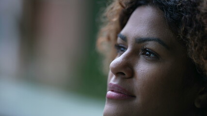 Pensive black woman, contemplative Brazilian girl close-up face in tranquility