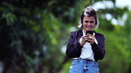 Joyful girl receiving successful message on phone