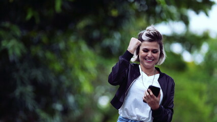 Joyful girl receiving successful message on phone