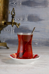 a glass of Turkish tea and a samovar on the table