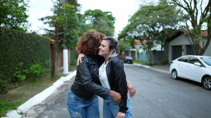 Obraz premium Friends embrace, two women hug, diversity concept