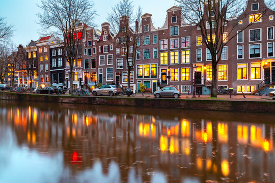 Evening Amsterdam canal Leidsegracht with typical dutch houses at gold hour, Holland, Netherlands. © Kavalenkava