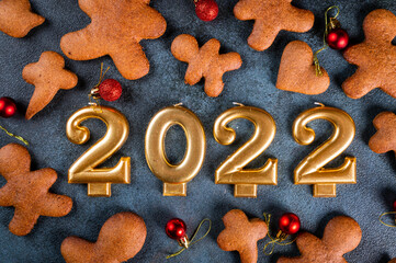 Homemade gingerbread cookies on dark background. Christmas composition, new year background. Number 2022 with cookies. Christmas banner. New Year banner.