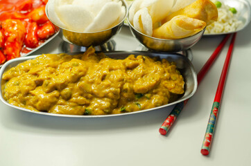 Chinese set,  chicken curry, sweet and sour chicken served with egg fried rice, vegetable spring rolls, and prawn crackers
