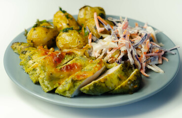 Pesto and mozzarella chicken breast fillet with herby baby potatoes and creamy coleslaw salad