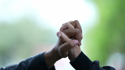 Close-up hands together joining forces, support diversity concept