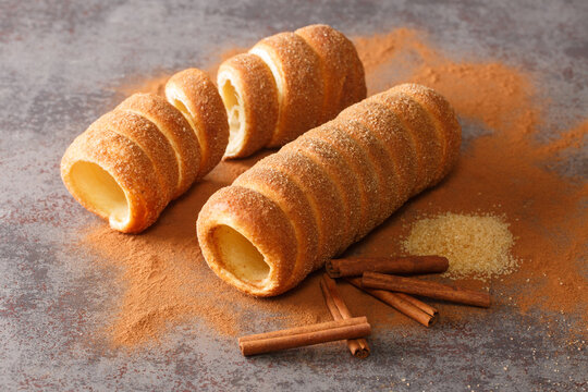 Trdeln&iacute;k Czech is a kind of spit cake it is made from rolled dough that is wrapped around a stick, then grilled and topped with sugar and cinnamon close up on the table. Horizontal