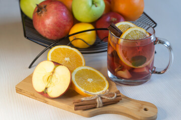 Fruit tea, various fruits in a basket on the table. Calendar 2022, winter mood and spruce branches.
