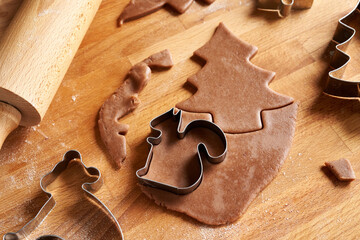 Cutting out a squirrel shape for gingerbread Christmas cookies