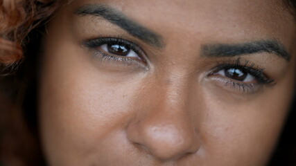 Fototapeta premium Hispanic black woman macro eyes close-up face looking at camera