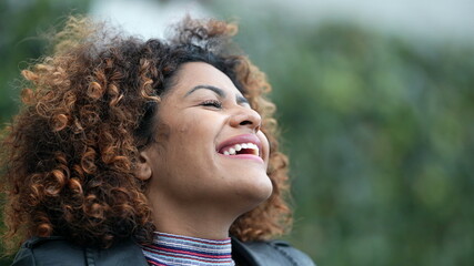 Ecstatic woman feeling happy looking at sky. Joyful person with HOPE