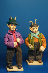Wooden painted figurine of two devils.