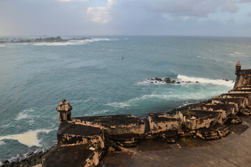 Stormy ocean and cloudy sky with old fortification wall, view from Castillo San Felipe del Morro, Old San Juan Puerto Rico