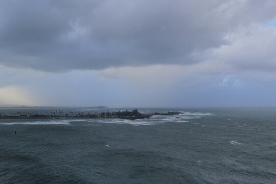 Stormy ocean with cloudy sky, with island in a background, view from Castillo San Felipe del Morro, Puerto Rico