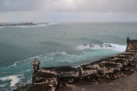 Stormy ocean and cloudy sky with old fortification wall, view from Castillo San Felipe del Morro, Old San Juan Puerto Rico
