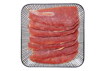 Spanish food. Top view of pieces of sliced dry spanish ham (Jamon Serrano) or italian parma...