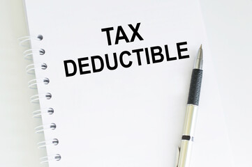 text Tax Deductions. Business concept for Finance Incoming Tax Money Deduction written sticky note paper