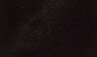 Night sky with in area near constellation Andromeda, five distinct stars forming Cassiopeia visible in lower left