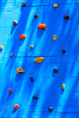 Background of the climbing wall with toe and hand hold studs