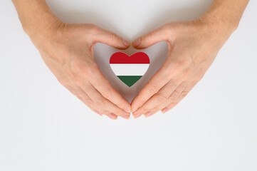 The national flag of Hungary in female hands. The concept of patriotism, respect and solidarity...