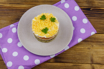 Traditional russian salad Mimosa on wooden table. Top view