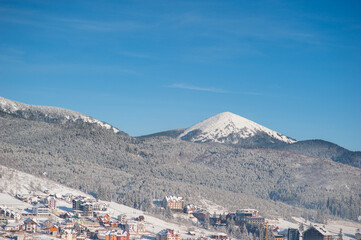 Fototapeta premium ski resort in the mountains with blue sky and snow