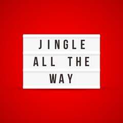 Christmas quote on a light box letter sign with red background: Jingle all the way.