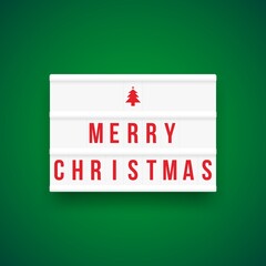 Christmas quote on a light box letter sign with green background: Merry Christmas.