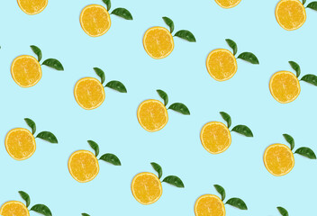 Colorful fruit pattern of fresh orange slices on blue background. From top view