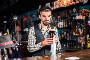 Professional barman makes a show creating a cocktail on the bar