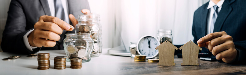 Mini house on stack of coins. Concept of Investment property.
