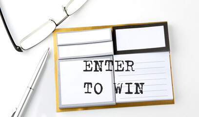 ENTER TO WIN text on sticky notes with glasses and pen, business concept