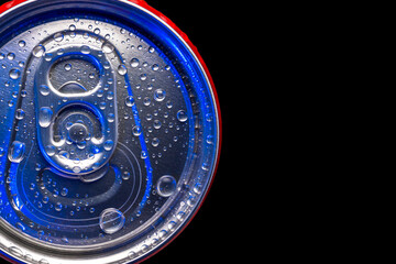 Top view of a red closed aluminum can with water droplets on a black background. Beautiful blue light on the surface of the metal.