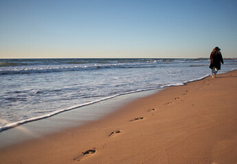 Girl walking on the beach. 