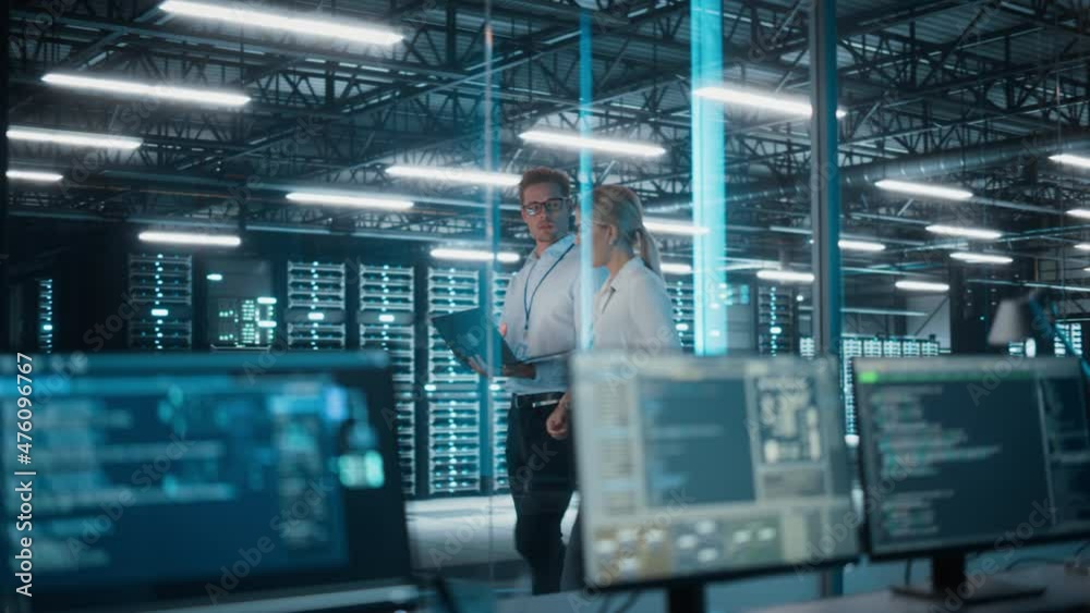 Poster data center server room: female e-business enrepreneur and male it specialist talk, use laptop, walk