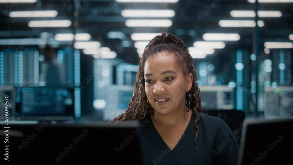 Poster portrait of african american female it specialist working on desktop in data center. system administ