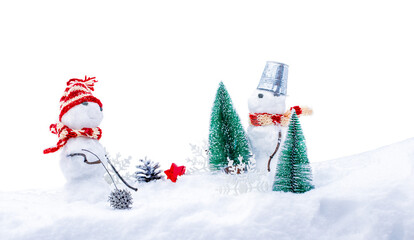 Cute snowmans in funny hats and scarfs with fir trees in deep in  snowdrift
