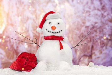 Little snowmen on soft snow on nature background in winter on snowfall